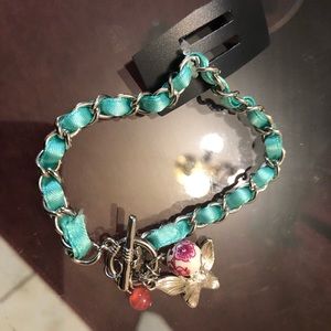 Pretty green bracelet with three charms.